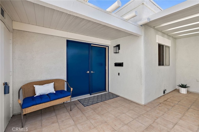 2133 Via Puerta Unit A, Laguna Woods, CA 92637 - property entrance with a patio, stucco siding, and french doors