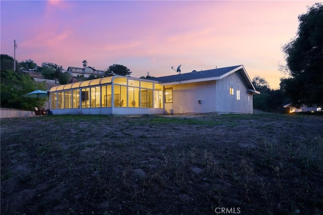 320 Casa Real Pl, Nipomo, CA 93444 - back of property at dusk with a sunroom and stucco siding