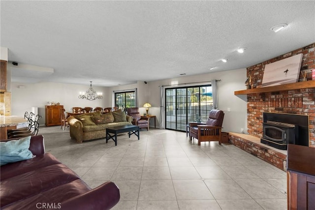 320 Casa Real Pl, Nipomo, CA 93444 - living room featuring a textured ceiling, a chandelier, a wood stove, and light tile patterned floors