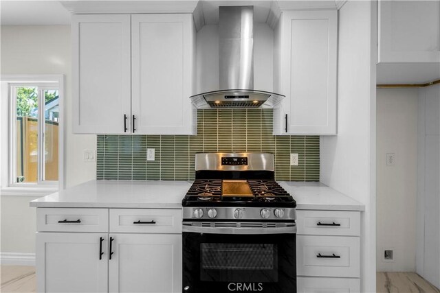4251 Gundry Ave, Long Beach, CA 90807 - kitchen featuring stainless steel gas range oven, wall chimney exhaust hood, decorative backsplash, and white cabinetry
