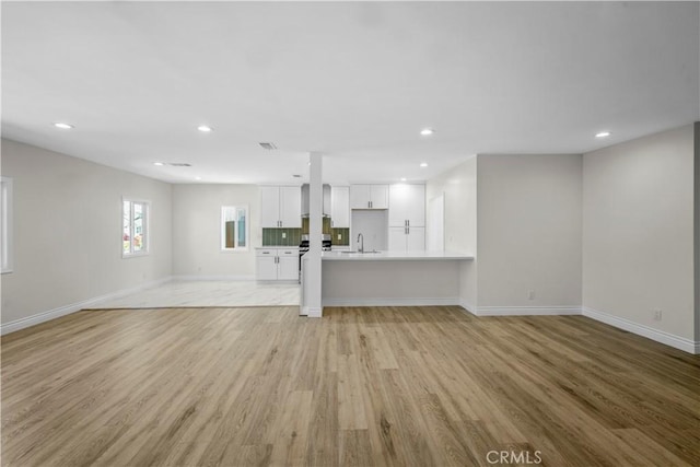 4251 Gundry Ave, Long Beach, CA 90807 - unfurnished living room featuring light wood-style flooring and recessed lighting