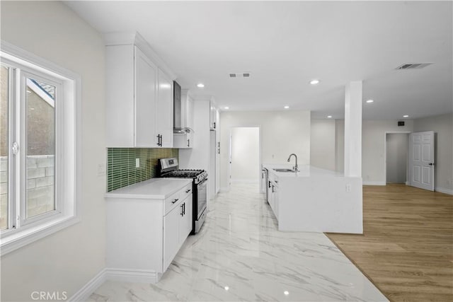 4251 Gundry Ave, Long Beach, CA 90807 - kitchen featuring stainless steel gas stove, white cabinetry, light countertops, decorative backsplash, and recessed lighting