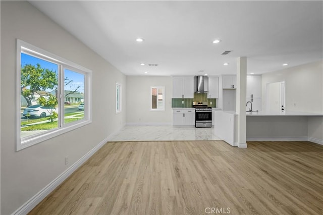 4251 Gundry Ave, Long Beach, CA 90807 - unfurnished living room with light wood-style floors and recessed lighting