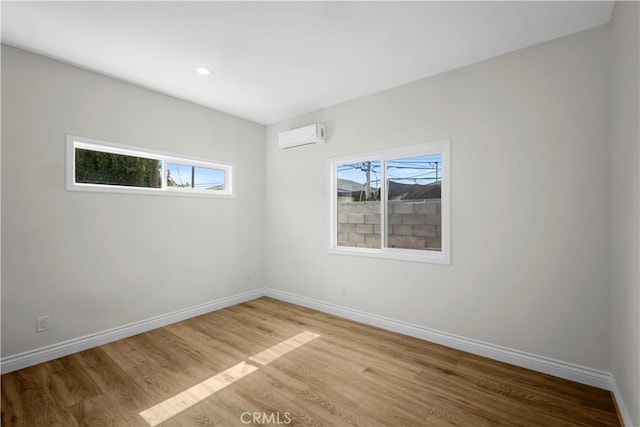 4251 Gundry Ave, Long Beach, CA 90807 - spare room featuring light wood-style floors, plenty of natural light, an AC wall unit, and recessed lighting