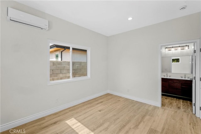 4251 Gundry Ave, Long Beach, CA 90807 - unfurnished bedroom featuring a wall mounted AC, light wood finished floors, connected bathroom, and recessed lighting