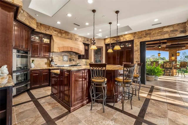 25492 Spotted Pony Ln, Laguna Hills, CA 92653 - bar with custom range hood, recessed lighting, a warming drawer, a skylight, and inlaid floor details