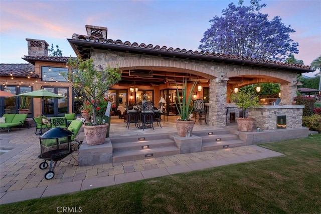 25492 Spotted Pony Ln, Laguna Hills, CA 92653 - rear view of house with a patio area, stone siding, an outdoor hangout area, and a yard