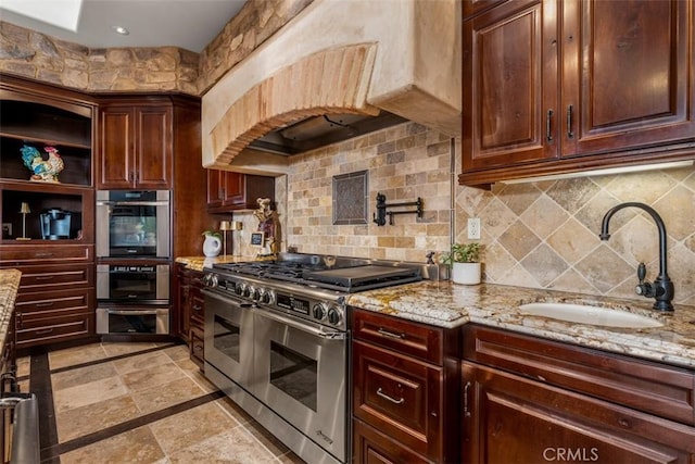 25492 Spotted Pony Ln, Laguna Hills, CA 92653 - kitchen with stainless steel appliances, light stone counters, decorative backsplash, and stone tile floors