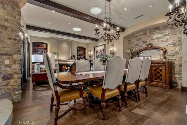 25492 Spotted Pony Ln, Laguna Hills, CA 92653 - dining room featuring hardwood / wood-style flooring, a chandelier, beamed ceiling, and a lit fireplace