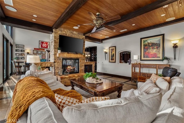25492 Spotted Pony Ln, Laguna Hills, CA 92653 - living room with a wood ceiling with exposed beams, a stone fireplace, ceiling fan, and recessed lighting