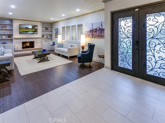 19520 Bermudas St, Porter Ranch, CA 91326 - entryway featuring french doors, ornamental molding, recessed lighting, a fireplace, and tile patterned floors