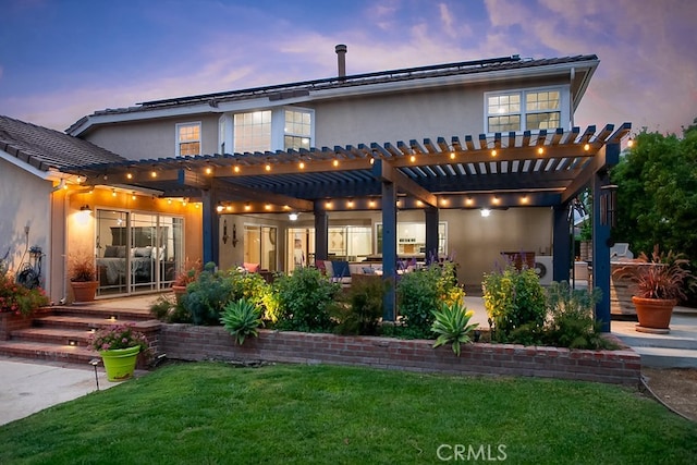 19520 Bermudas St, Porter Ranch, CA 91326 - rear view of property featuring a pergola, stucco siding, a lawn, and a patio area