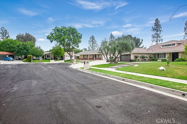 19520 Bermudas St, Porter Ranch, CA 91326 - view of asphalt street featuring sidewalks, a residential view, and curbs
