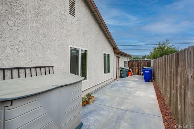 911 S Citrus Ave, Escondido, CA 92027 - view of property exterior with a hot tub, a patio, and stucco siding