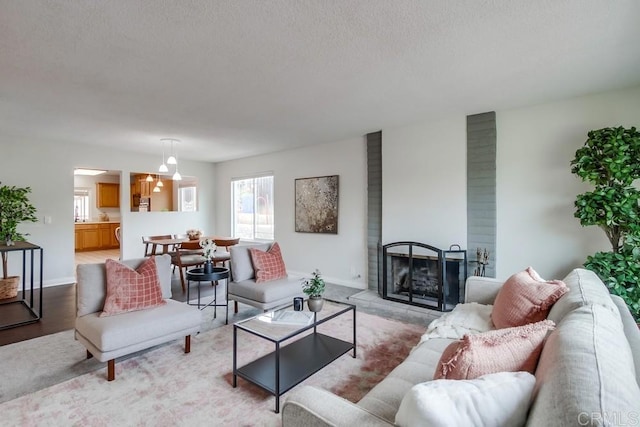911 S Citrus Ave, Escondido, CA 92027 - living room featuring a textured ceiling and a brick fireplace