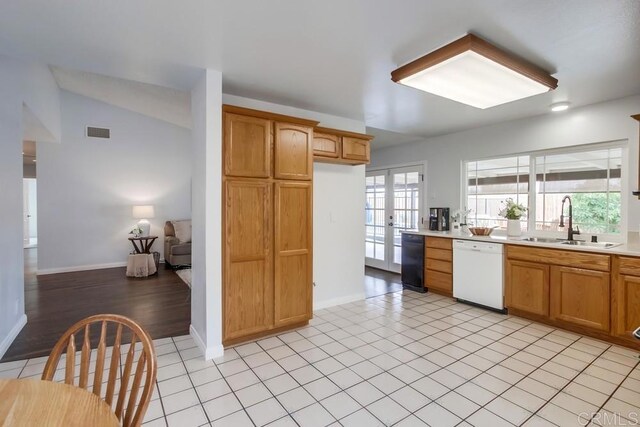 911 S Citrus Ave, Escondido, CA 92027 - kitchen featuring dishwasher, light countertops, lofted ceiling, light tile patterned floors, and french doors