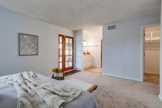 911 S Citrus Ave, Escondido, CA 92027 - carpeted bedroom with a textured ceiling, a spacious closet, and ensuite bath