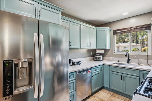 3443 Trophy Dr, La Mesa, CA 91941 - kitchen featuring appliances with stainless steel finishes, light countertops, light tile patterned flooring, blue cabinets, and recessed lighting