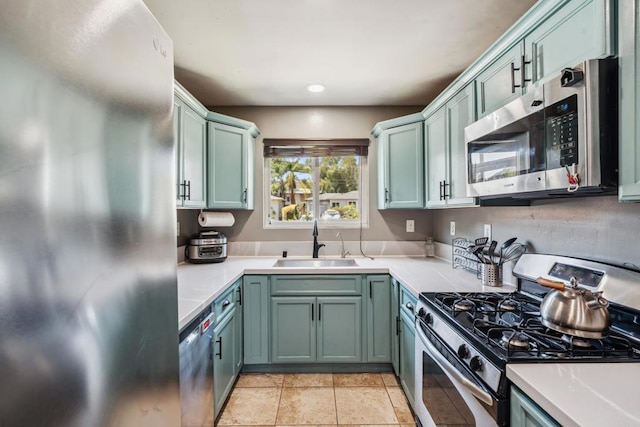 3443 Trophy Dr, La Mesa, CA 91941 - kitchen featuring appliances with stainless steel finishes, light countertops, recessed lighting, green cabinets, and light tile patterned floors
