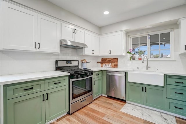 1276 Sao Paulo Ave, Placentia, CA 92870 - kitchen with green cabinetry, stainless steel appliances, under cabinet range hood, white cabinets, and recessed lighting
