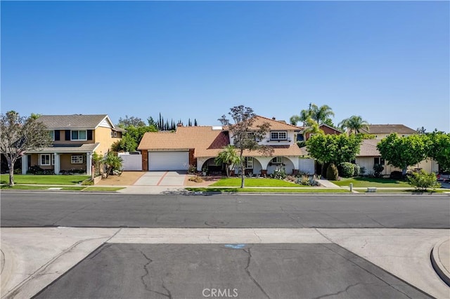 1276 Sao Paulo Ave, Placentia, CA 92870 - view of front facade featuring concrete driveway, a garage, a front lawn, a residential view, and a tiled roof