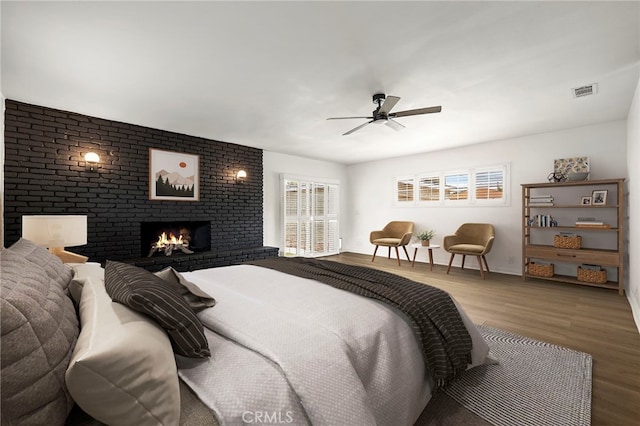 2871 Adriatic Ave, Long Beach, CA 90810 - bedroom featuring wood finished floors, a brick fireplace, and a ceiling fan