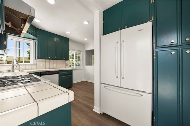 2871 Adriatic Ave, Long Beach, CA 90810 - kitchen featuring appliances with stainless steel finishes, tasteful backsplash, dark wood-style flooring, recessed lighting, and tile counters
