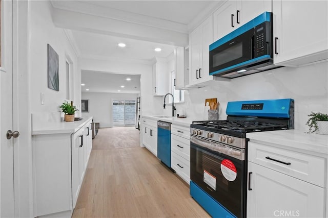 14867 Roxton Ave, Gardena, CA 90249 - kitchen with stainless steel gas stove, black microwave, dishwasher, crown molding, and white cabinets