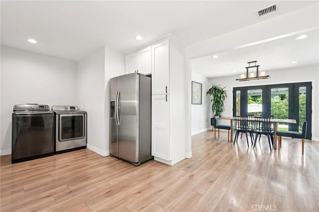 20042 Lassen St, Chatsworth, CA 91311 - kitchen with stainless steel fridge with ice dispenser, washing machine and dryer, white cabinets, light wood-style floors, and recessed lighting