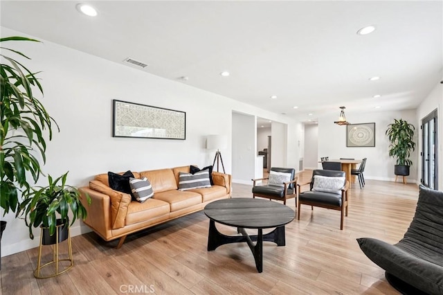 20042 Lassen St, Chatsworth, CA 91311 - living room with light wood-style floors and recessed lighting