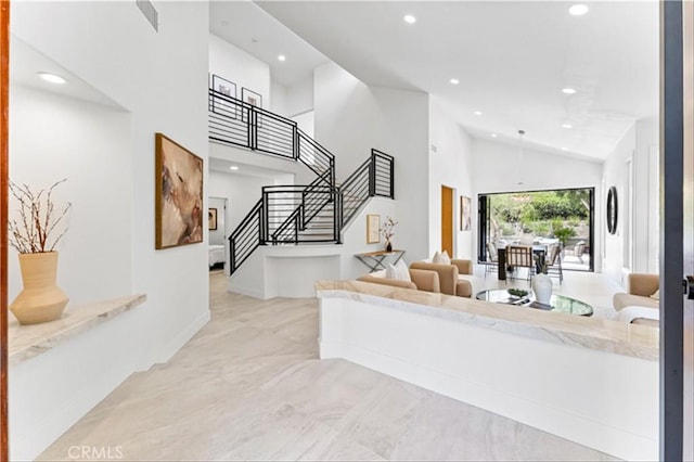 15 Glastonbury Pl, Laguna Niguel, CA 92677 - living room with recessed lighting, high vaulted ceiling, stairs, and marble finish flooring