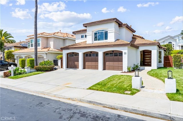 15 Glastonbury Pl, Laguna Niguel, CA 92677 - mediterranean / spanish house featuring an attached garage, concrete driveway, stucco siding, a front lawn, and a tile roof