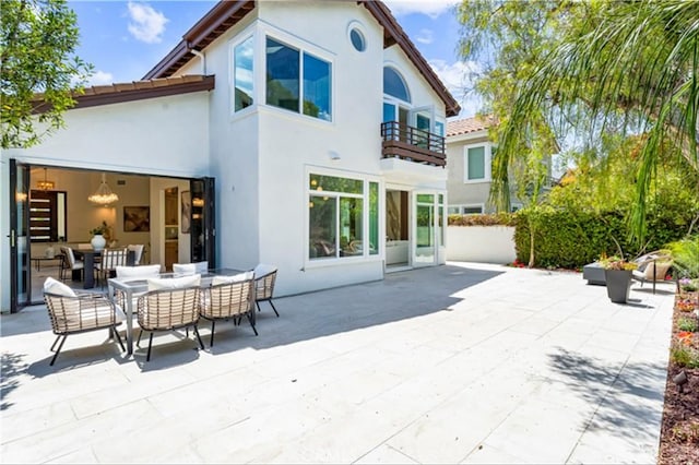 15 Glastonbury Pl, Laguna Niguel, CA 92677 - rear view of house featuring a balcony, stucco siding, a patio area, and outdoor dining space