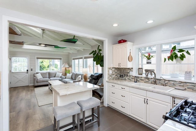 121 Cadmus St, Encinitas, CA 92024 - kitchen with white cabinets, gas range, backsplash, open floor plan, and recessed lighting