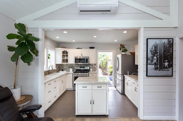 121 Cadmus St, Encinitas, CA 92024 - kitchen featuring appliances with stainless steel finishes, an AC wall unit, healthy amount of natural light, backsplash, and recessed lighting