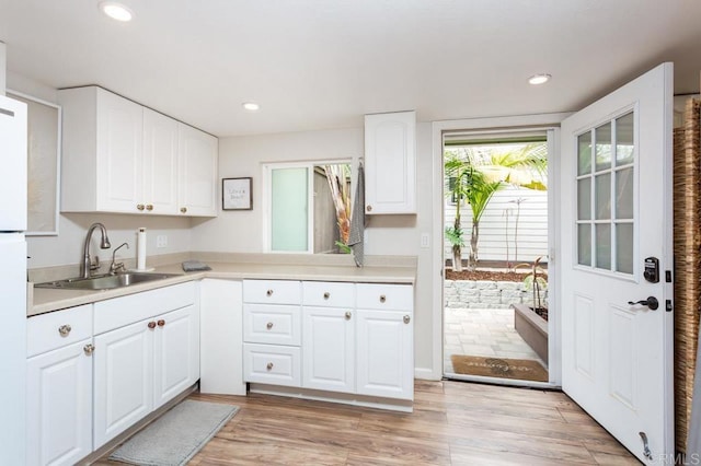 121 Cadmus St, Encinitas, CA 92024 - kitchen featuring white cabinets, light countertops, recessed lighting, and light wood-style floors