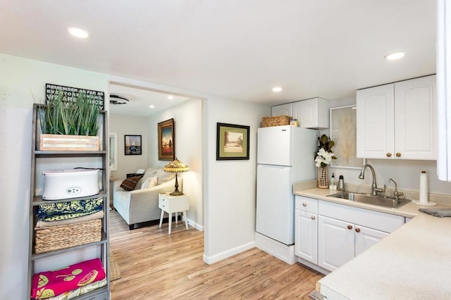 121 Cadmus St, Encinitas, CA 92024 - kitchen featuring freestanding refrigerator, white cabinets, light wood-type flooring, light countertops, and recessed lighting