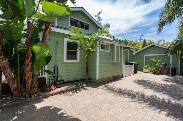 121 Cadmus St, Encinitas, CA 92024 - back of property with an outdoor structure and a patio area
