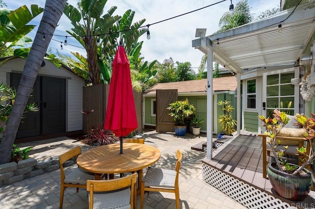 121 Cadmus St, Encinitas, CA 92024 - view of patio / terrace featuring a storage unit, a pergola, and outdoor dining space