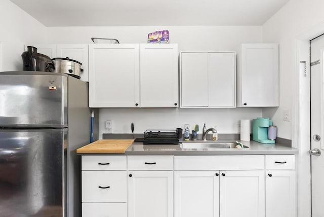216466 S 40th St, San Diego, CA 92113 - kitchen with freestanding refrigerator, white cabinets, and light countertops