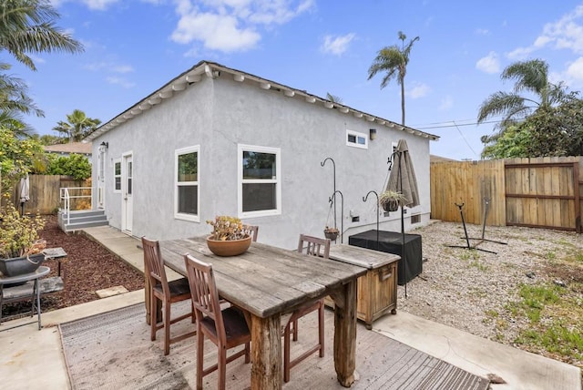 216466 S 40th St, San Diego, CA 92113 - rear view of house featuring stucco siding, a patio, and outdoor dining space