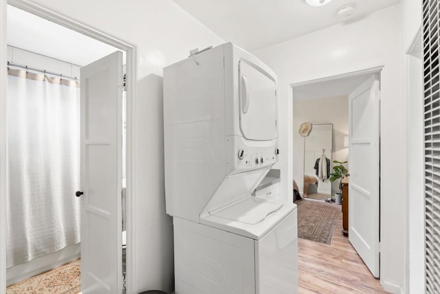 216466 S 40th St, San Diego, CA 92113 - laundry area featuring stacked washer / drying machine and light wood-style flooring