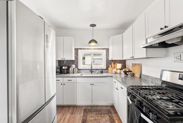 216466 S 40th St, San Diego, CA 92113 - kitchen with freestanding refrigerator, gas range, under cabinet range hood, and white cabinets