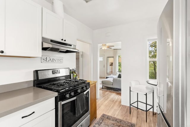 216466 S 40th St, San Diego, CA 92113 - kitchen featuring stainless steel gas stove, under cabinet range hood, and white cabinets