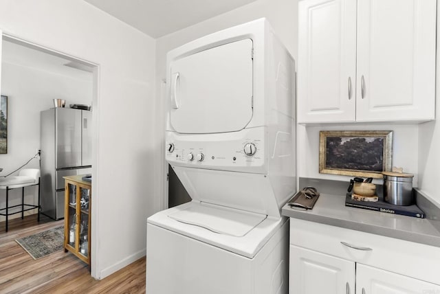 216466 S 40th St, San Diego, CA 92113 - laundry room featuring stacked washer and clothes dryer and light wood-style floors