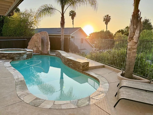 1675 Bronco Way, Oceanside, CA 92057 - pool at dusk with a fenced backyard, a water slide, and a pool with connected hot tub