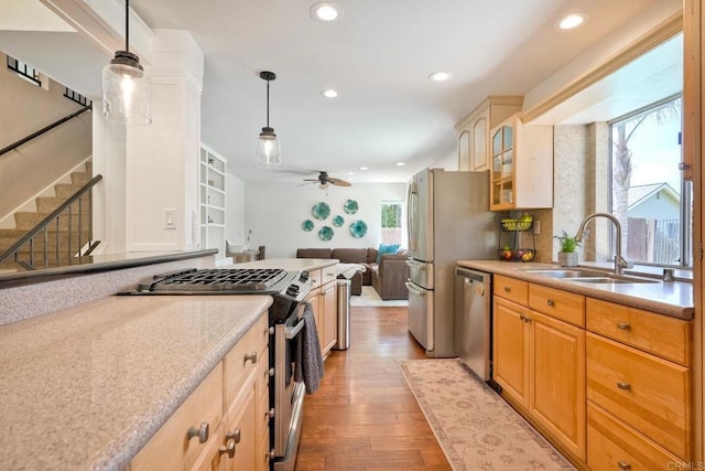 1675 Bronco Way, Oceanside, CA 92057 - kitchen featuring appliances with stainless steel finishes, a ceiling fan, light wood-style floors, recessed lighting, and glass insert cabinets