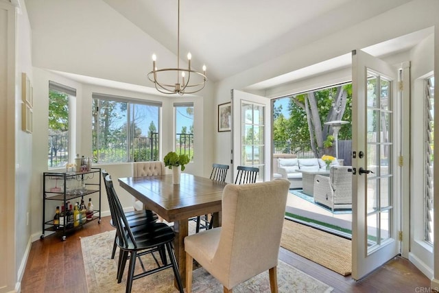 1675 Bronco Way, Oceanside, CA 92057 - dining room featuring lofted ceiling, wood finished floors, a chandelier, and french doors