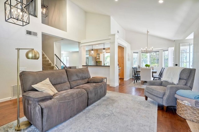 1675 Bronco Way, Oceanside, CA 92057 - living room with a chandelier, dark wood-style flooring, stairway, high vaulted ceiling, and recessed lighting