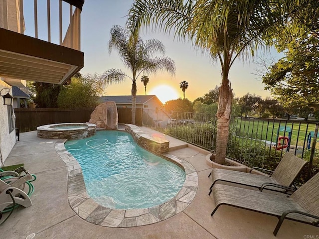 1675 Bronco Way, Oceanside, CA 92057 - pool at dusk featuring a fenced backyard, a patio, and a pool with connected hot tub